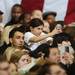 A young audience member gets a lift for a better view of President Obama as he addresses an audience of 3,000 at the Al Glick Fieldhouse on Friday morning.  Melanie Maxwell I AnnArbor.com